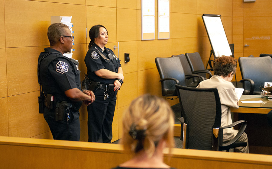 Correctional officers in a courtroom